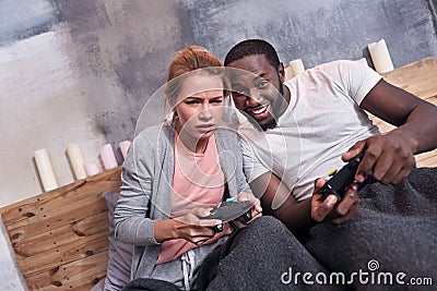 Joyful couple playing videogames together Stock Photo