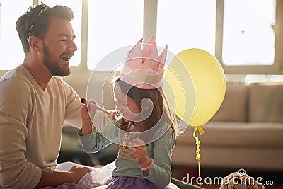 Joyful dad and daughter dressing up toghether Stock Photo