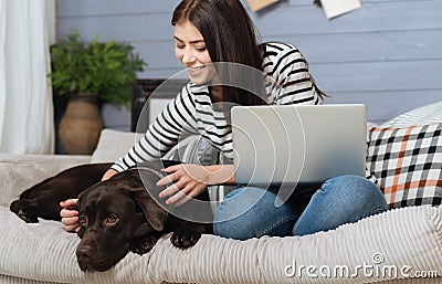 Joyful elegant woman petting her cute Labrador Stock Photo