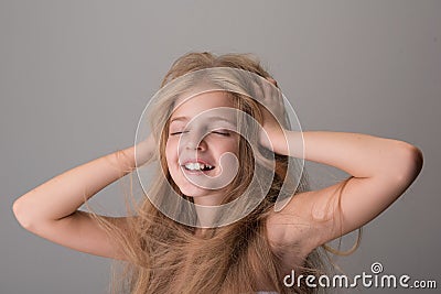 Joyful endearing child is smiling and feeling pleasure Stock Photo
