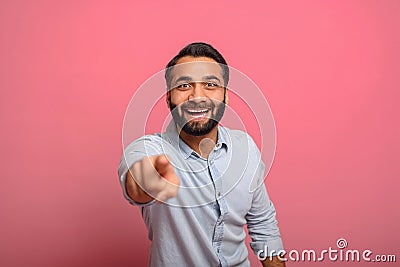 Joyful excited Indian middle-aged man in jeans shirt points fingers at the camera Stock Photo