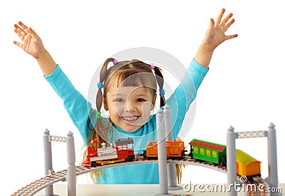Joyful girl playing with toy railway Stock Photo