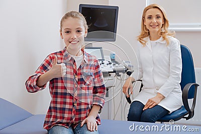 Joyful girl recommending excellent service of the clinic Stock Photo