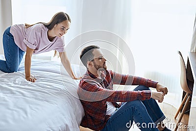 Joyful girl trying to play with boyfriend Stock Photo