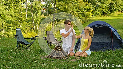 Joyful haired blonde girl high fives her boyfriend after collecting firewood. Stock Photo