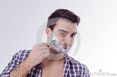 Joyful happy man shaving in the morning Stock Photo