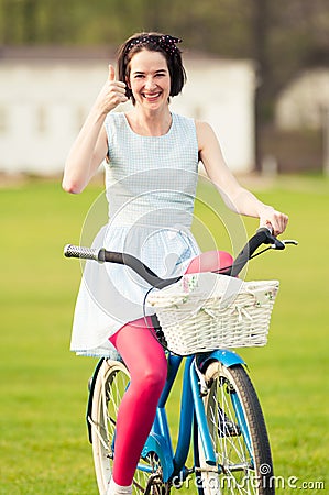 Joyful hipster doing like or thumbup gesture in the park Stock Photo