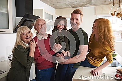 Joyful kid surrounded by her dearest at home Stock Photo
