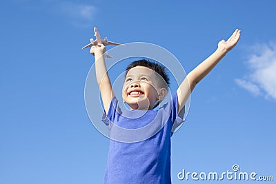 Joyful little boy holding a toy with blue sky Stock Photo