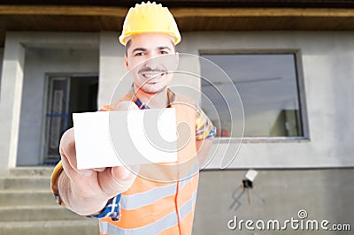 Joyful male builder showing blank visit card Stock Photo