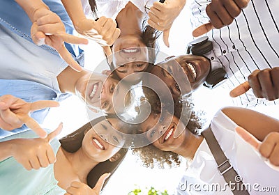 Joyful Multicultural Teenagers Standing In Circle, Showing Funny Gestures, Low Angle Stock Photo