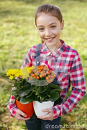 Joyful nice girl being interested in flowers Stock Photo