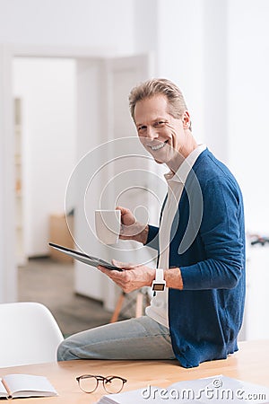 Joyful nice man wearing the watch Stock Photo