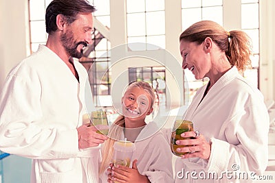 Joyful nice parents taking their daughter to the spa Stock Photo