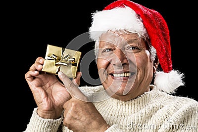 Joyful Old Man Gesturing At Wrapped Golden Gift Stock Photo