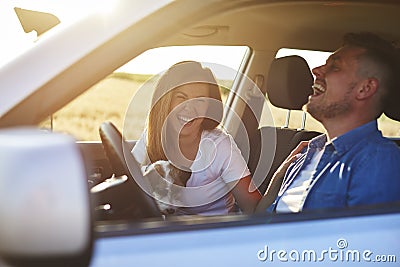 Joyful scene of young couple and dog during road trip Stock Photo