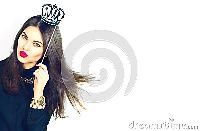 Joyful model girl holding funny paper crown on stick isolated on white Stock Photo