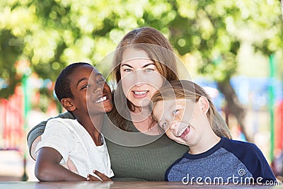 Joyful single parent with sons at park table Stock Photo