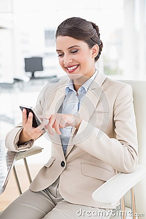 Joyful smart brown haired businesswoman using a mobile phone Stock Photo