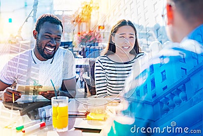Joyful students spending weekend in the cafe Stock Photo