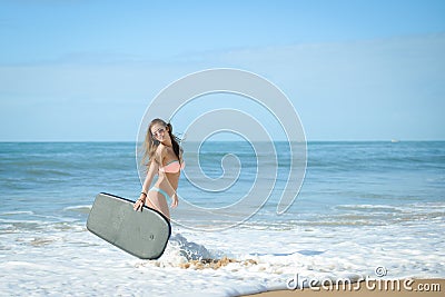 Joyful surfer girl happy cheerful at ocean beach water. Stock Photo