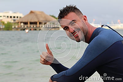 Joyful surfer giving a thumbs up Stock Photo