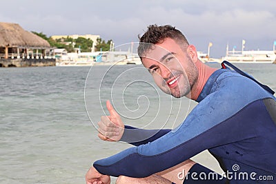 Joyful surfer giving a thumbs up Stock Photo