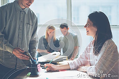 Joyful team brainstorming. New marketing plan researching. Paperwork on the table, laptop and mobile phone Stock Photo