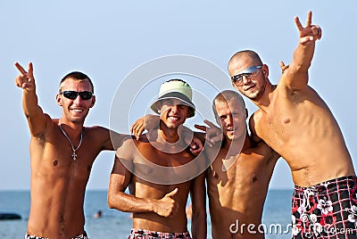 Joyful team of friends having fun at the beach Stock Photo