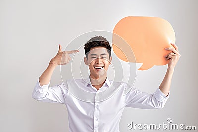 Joyful thinking man holding white empty speech balloon with space for text isolated on white background Stock Photo