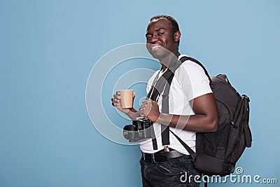 Joyful tourist having DSLR device while being excited for citybreak Stock Photo
