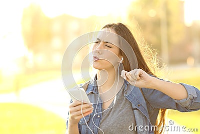 Joyful woman listening music from a smart phone Stock Photo