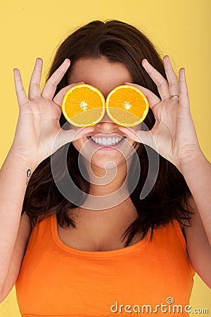 Joyful Woman With Orange Slices Over Eyes Stock Photo