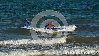 Joyful young woman beginner surfer Editorial Stock Photo