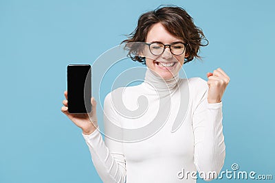 Joyful young woman in casual white clothes eyeglasses isolated on pastel blue background. People lifestyle concept. Mock Stock Photo