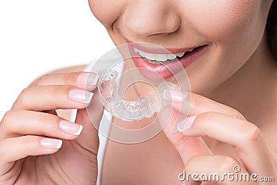 Joyful young woman undergoing clear-aligner treatment Stock Photo