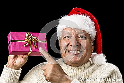 Joyous Old Man Pointing At Magenta Wrapped Gift Stock Photo