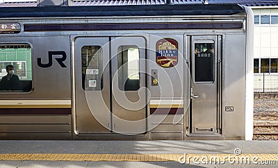 JR train stopping at station in Hiroshima, Japan Editorial Stock Photo