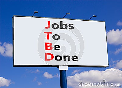 JTBD jobs to be done symbol. Concept words JTBD jobs to be done on white billboard against beautiful blue sky and white clouds. Stock Photo