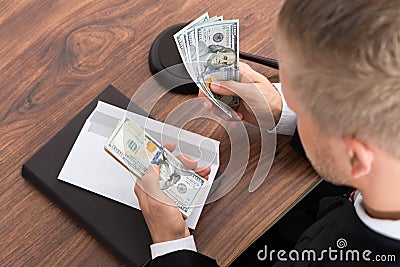 Judge Counting Money In Courtroom Stock Photo