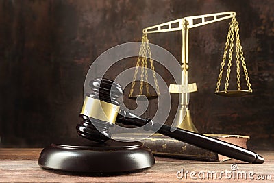 Judge gavel, book and scales on the wooden lawyers desk, justice Stock Photo