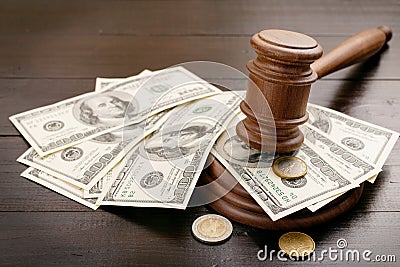 Judge gavel with dollars and euro cents Stock Photo
