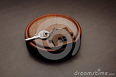 Judge gavel and key chain in shape of two splitted part of house on wooden background. Concept of real estate auction or Stock Photo