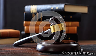 Judge gavel on a wooden desk, law books background Stock Photo