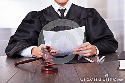 Judge holding documents Stock Photo