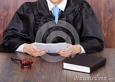 Judge holding documents Stock Photo