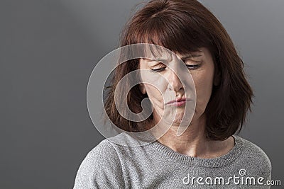 Judge mental concept for unhappy 50s woman Stock Photo