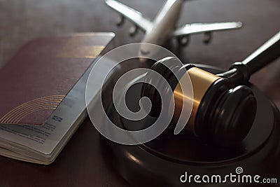 Judge`s gavel, airplane and passport. Concept of international law, immigration law and citizenship rights Stock Photo