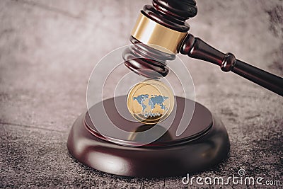 Judge's gavel holding a descriptive cryptocurrency coin. Editorial Stock Photo