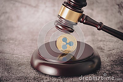 Judge's gavel holding a descriptive cryptocurrency coin. Editorial Stock Photo